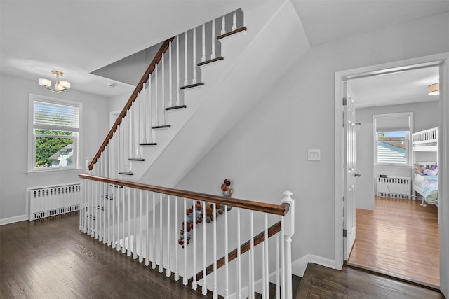 269 Hayward St, Yonkers, NY 10704 - stairs with radiator, wood finished floors, and baseboards