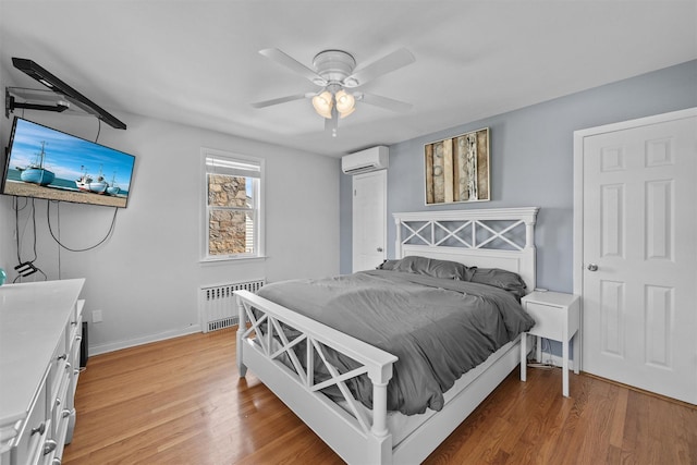 269 Hayward St, Yonkers, NY 10704 - bedroom featuring radiator, light wood finished floors, baseboards, and a wall unit AC
