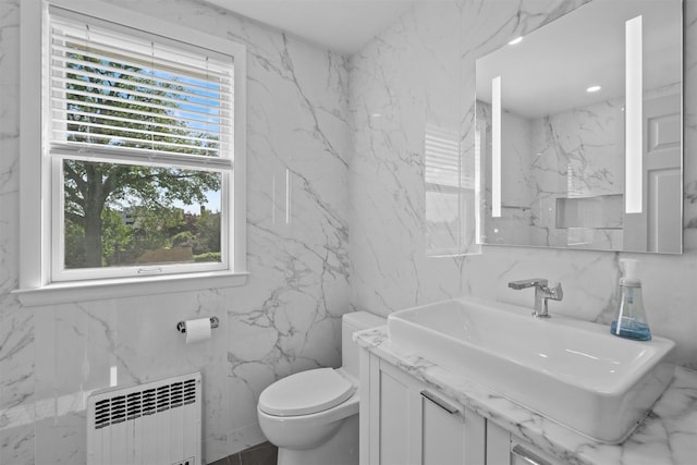 269 Hayward St, Yonkers, NY 10704 - bathroom with radiator, a sink, tile walls, and toilet