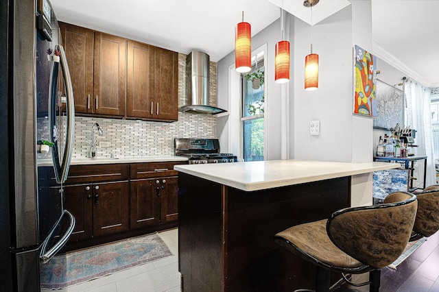 67-66 108th St Unit A32, Forest Hills, NY 11375 - kitchen with freestanding refrigerator, wall chimney exhaust hood, gas stove, a sink, and light countertops