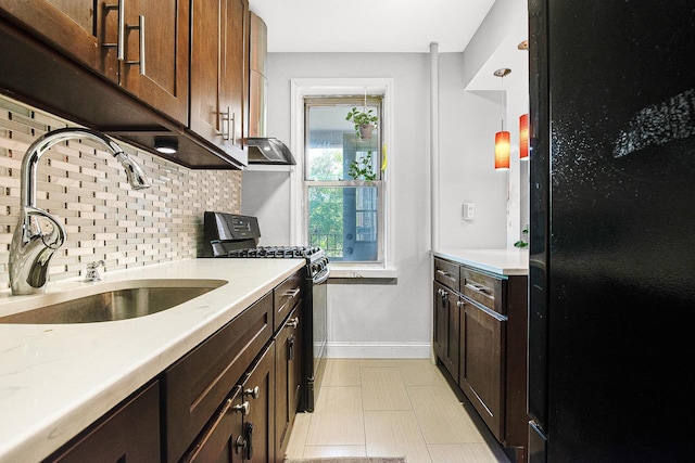 67-66 108th St Unit A32, Forest Hills, NY 11375 - kitchen featuring black appliances, a sink, backsplash, baseboards, and light countertops