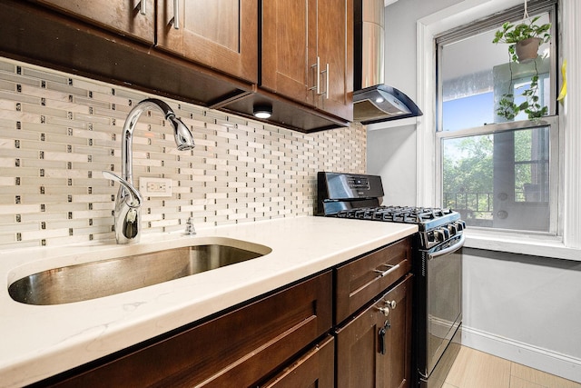 67-66 108th St Unit A32, Forest Hills, NY 11375 - kitchen featuring range with gas cooktop, a sink, tasteful backsplash, and dark brown cabinets