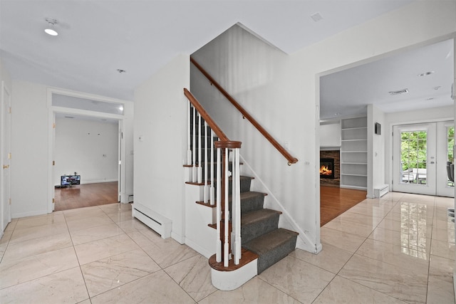32 Wilder Rd, Monsey, NY 10952 - stairway featuring a baseboard heating unit, a warm lit fireplace, marble look tiles, baseboards, and baseboard heating