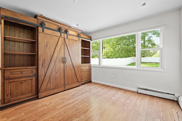 32 Wilder Rd, Monsey, NY 10952 - unfurnished bedroom featuring multiple windows, light wood-type flooring, baseboards, and a baseboard radiator