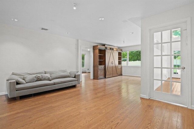 32 Wilder Rd, Monsey, NY 10952 - living room with a barn door, light wood-style flooring, and baseboards