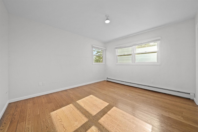 32 Wilder Rd, Monsey, NY 10952 - spare room featuring baseboard heating, wood finished floors, and baseboards