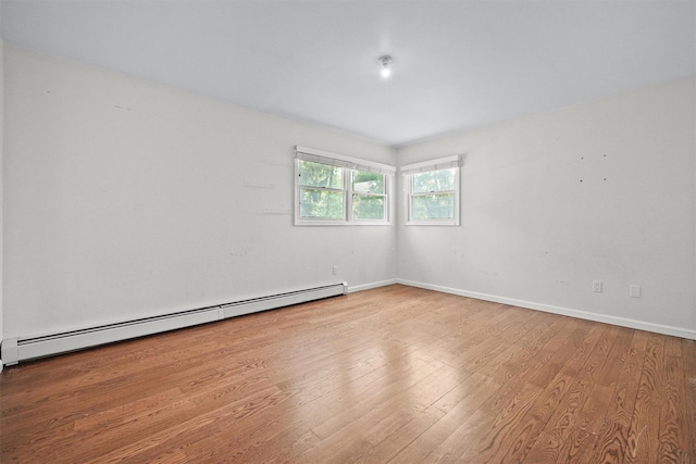 32 Wilder Rd, Monsey, NY 10952 - spare room featuring baseboard heating, wood finished floors, and baseboards