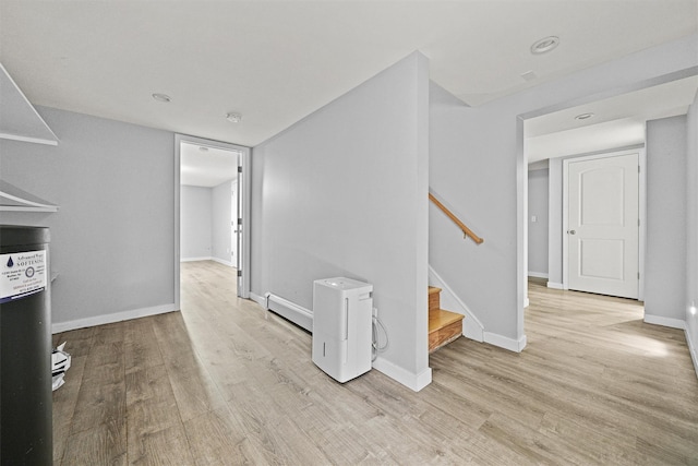 32 Wilder Rd, Monsey, NY 10952 - hall with light wood-style floors, stairway, baseboards, and a baseboard heating unit