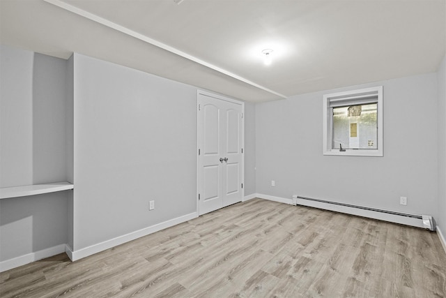 32 Wilder Rd, Monsey, NY 10952 - unfurnished bedroom featuring baseboard heating, wood finished floors, and baseboards