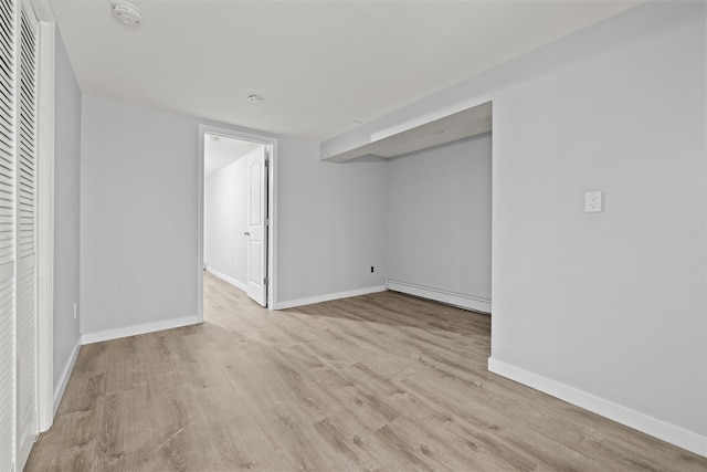 32 Wilder Rd, Monsey, NY 10952 - empty room with baseboard heating, a smoke detector, wood finished floors, and baseboards