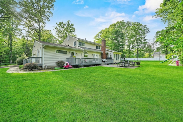 32 Wilder Rd, Monsey, NY 10952 - rear view of house with a wooden deck, a patio area, a playground, and a chimney