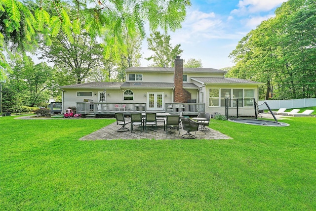 32 Wilder Rd, Monsey, NY 10952 - back of house featuring a chimney, a sunroom, a patio, a wooden deck, and french doors