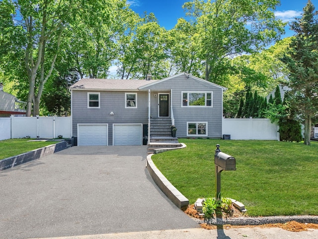 view of front of home featuring asphalt driveway and an attached garage