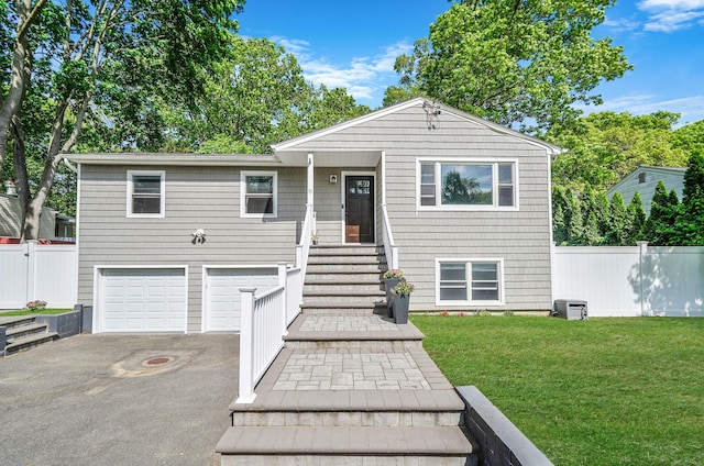 view of front of house featuring asphalt driveway and an attached garage