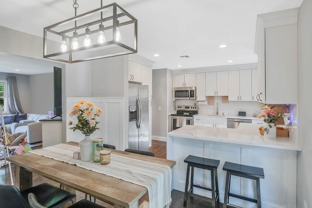 dining room with dark wood-style flooring and recessed lighting