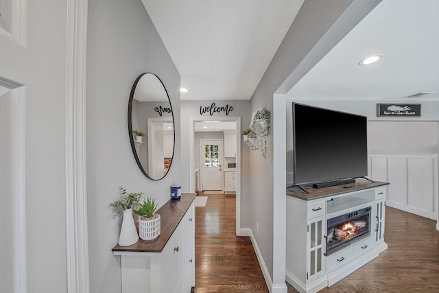 hall featuring dark wood finished floors, recessed lighting, and baseboards