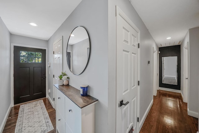 entrance foyer with dark wood-style flooring, baseboards, and recessed lighting