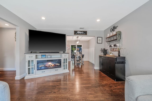 living area featuring wood finished floors, baseboards, and recessed lighting