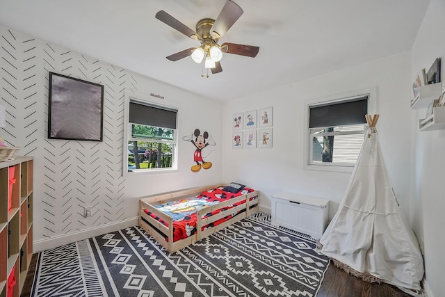 bedroom with baseboards, a ceiling fan, and wood finished floors