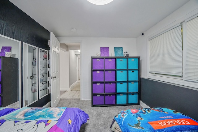 bedroom featuring carpet and baseboards