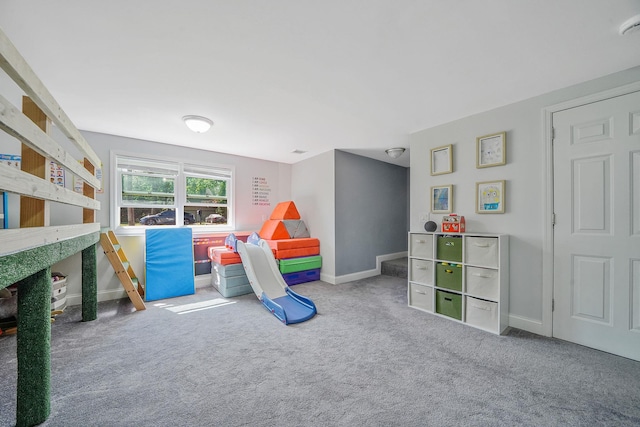 rec room featuring carpet floors and baseboards
