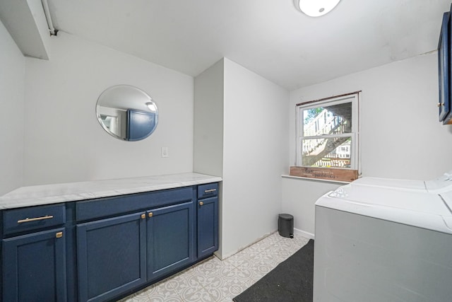 laundry area featuring independent washer and dryer, cabinet space, and baseboards