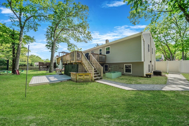rear view of property with a wooden deck, stairway, and cooling unit