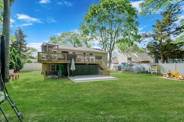 rear view of house with stairs, a wooden deck, and a patio