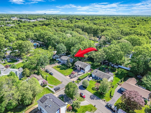 aerial view of property's location with a heavily wooded area