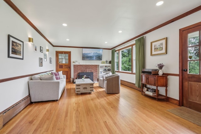 275 Otterkill Rd, Cornwall, NY 12553 - living area with ornamental molding, baseboard heating, light wood finished floors, healthy amount of natural light, and a fireplace