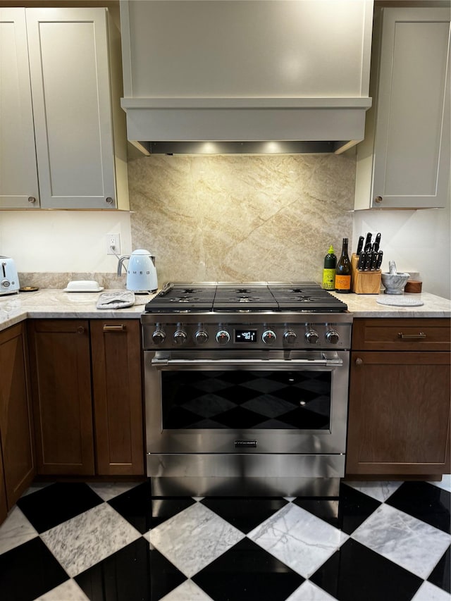 275 Otterkill Rd, Cornwall, NY 12553 - kitchen featuring high end range, wall chimney range hood, decorative backsplash, light stone countertops, and tile patterned floors