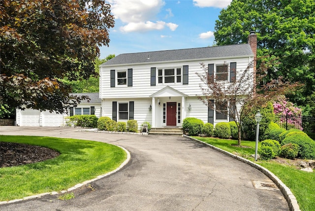 50 Kerry Ln, Chappaqua, NY 10514 - colonial house with a chimney, curved driveway, and a garage