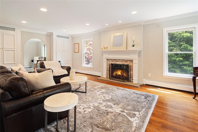 50 Kerry Ln, Chappaqua, NY 10514 - living room with a baseboard radiator, arched walkways, ornamental molding, healthy amount of natural light, and a fireplace