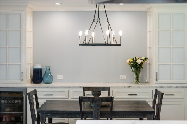50 Kerry Ln, Chappaqua, NY 10514 - dining room with wine cooler, ornamental molding, and a chandelier