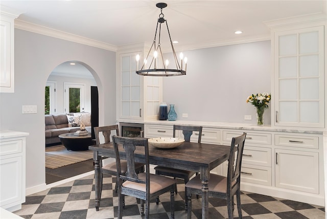 50 Kerry Ln, Chappaqua, NY 10514 - dining area featuring arched walkways, a chandelier, crown molding, dark floors, and recessed lighting