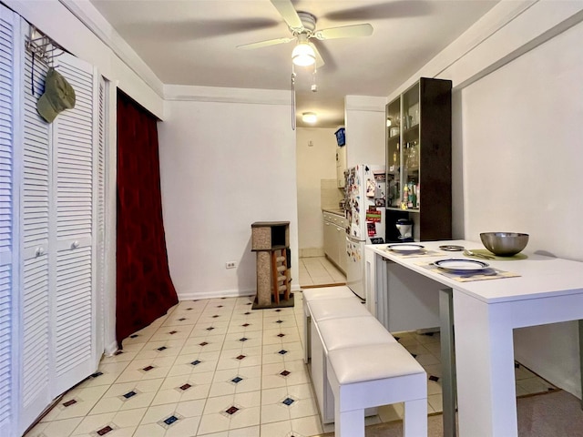 142-05 Roosevelt Ave Unit 301, Flushing, NY 11354 - kitchen with a ceiling fan, glass insert cabinets, a peninsula, and light countertops