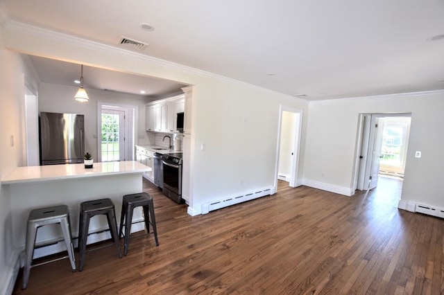 9 Circuit Rd, Bellport Village, NY 11713 - kitchen with freestanding refrigerator, a baseboard radiator, dark wood finished floors, white cabinetry, and light countertops