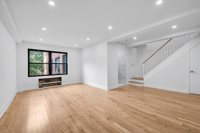 99-52 66th Rd Unit 3G, Rego Park, NY 11374 - unfurnished living room featuring light wood-style flooring, recessed lighting, and stairs