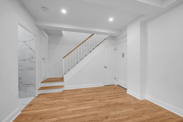 99-52 66th Rd Unit 3G, Rego Park, NY 11374 - below grade area with stairs, wood finished floors, and recessed lighting