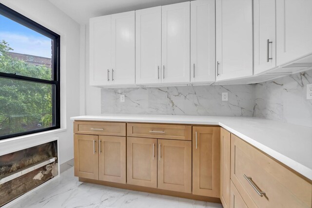 99-52 66th Rd Unit 3G, Rego Park, NY 11374 - kitchen featuring light countertops, decorative backsplash, and white cabinetry