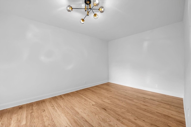 99-52 66th Rd Unit 3G, Rego Park, NY 11374 - empty room featuring a chandelier and wood finished floors