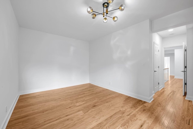 99-52 66th Rd Unit 3G, Rego Park, NY 11374 - spare room featuring light wood finished floors and a chandelier