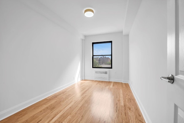 99-52 66th Rd Unit 3G, Rego Park, NY 11374 - unfurnished room with radiator heating unit and light wood-style flooring