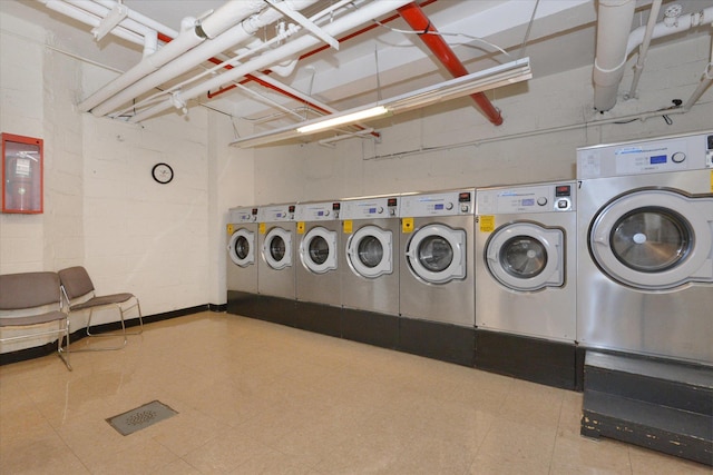 99-52 66th Rd Unit 3G, Rego Park, NY 11374 - community laundry with washing machine and clothes dryer and tile patterned floors