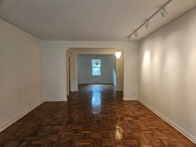 1361 Broadway Unit B26, Hewlett, NY 11557 - empty room featuring baseboards, track lighting, and arched walkways