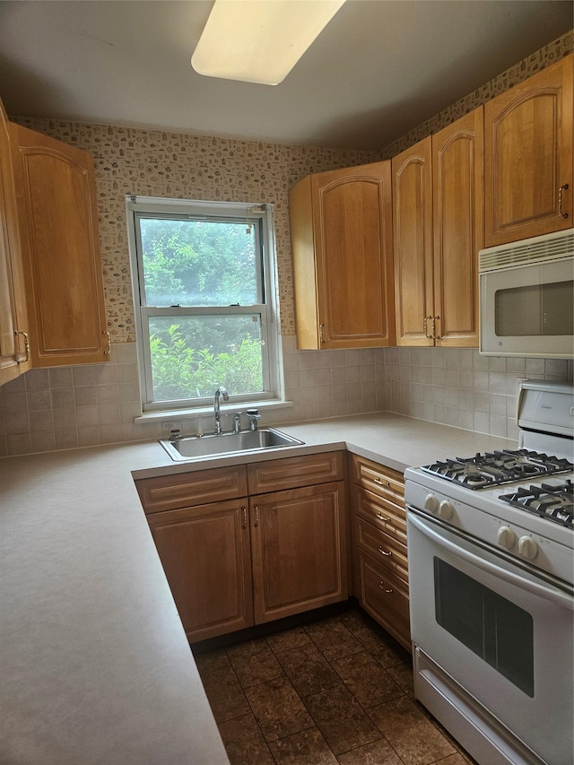 1361 Broadway Unit B26, Hewlett, NY 11557 - kitchen featuring white appliances, a sink, light countertops, and decorative backsplash