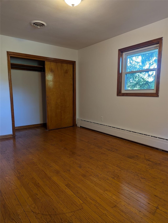 118 Mac Farlane Rd, Wappingers Falls, NY 12590 - unfurnished bedroom with a baseboard radiator, wood finished floors, a closet, and baseboards