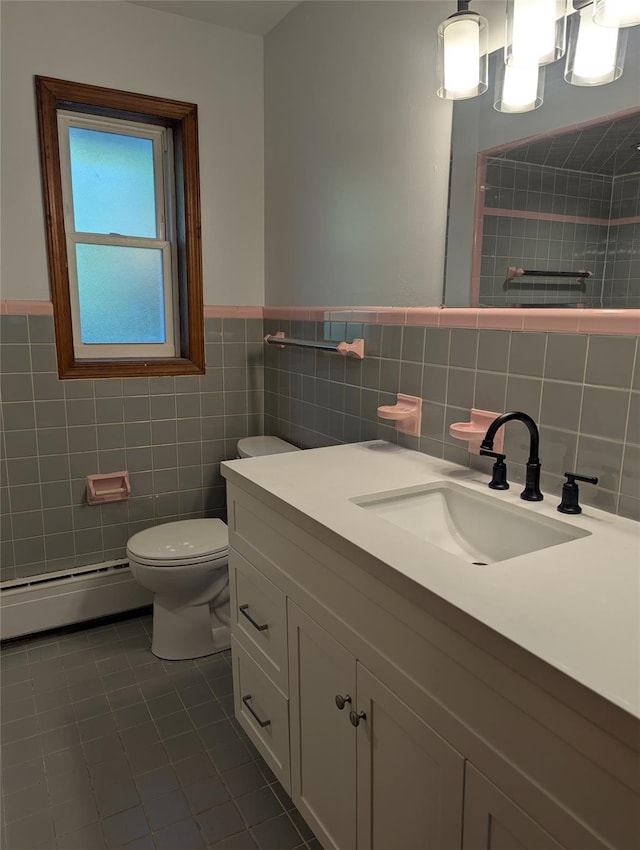 118 Mac Farlane Rd, Wappingers Falls, NY 12590 - bathroom with a baseboard heating unit, tile walls, tile patterned flooring, toilet, and vanity