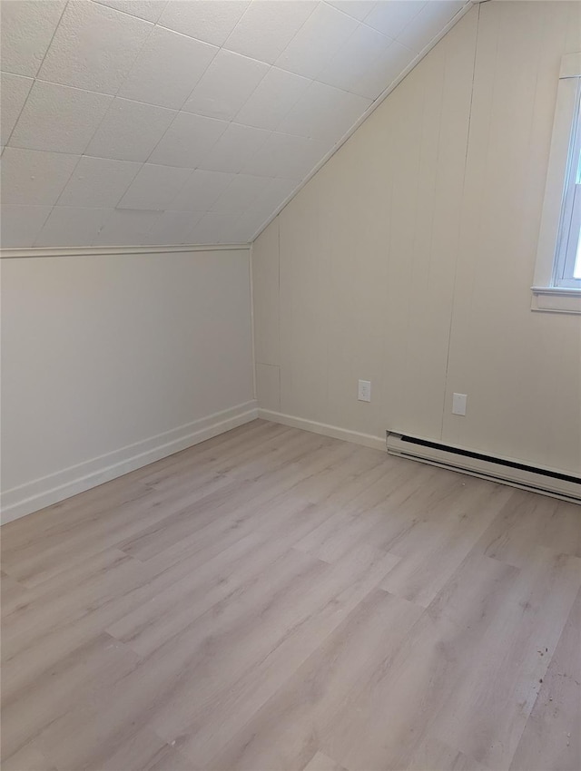 118 Mac Farlane Rd, Wappingers Falls, NY 12590 - additional living space featuring light wood-style flooring, vaulted ceiling, baseboard heating, and baseboards