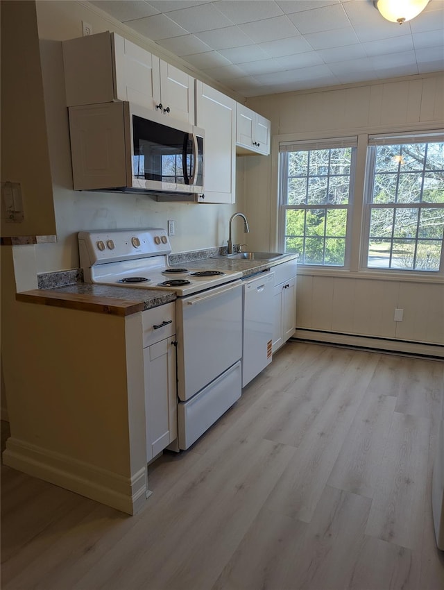 118 Mac Farlane Rd, Wappingers Falls, NY 12590 - kitchen with white appliances, a sink, a baseboard radiator, light wood-style flooring, and white cabinetry